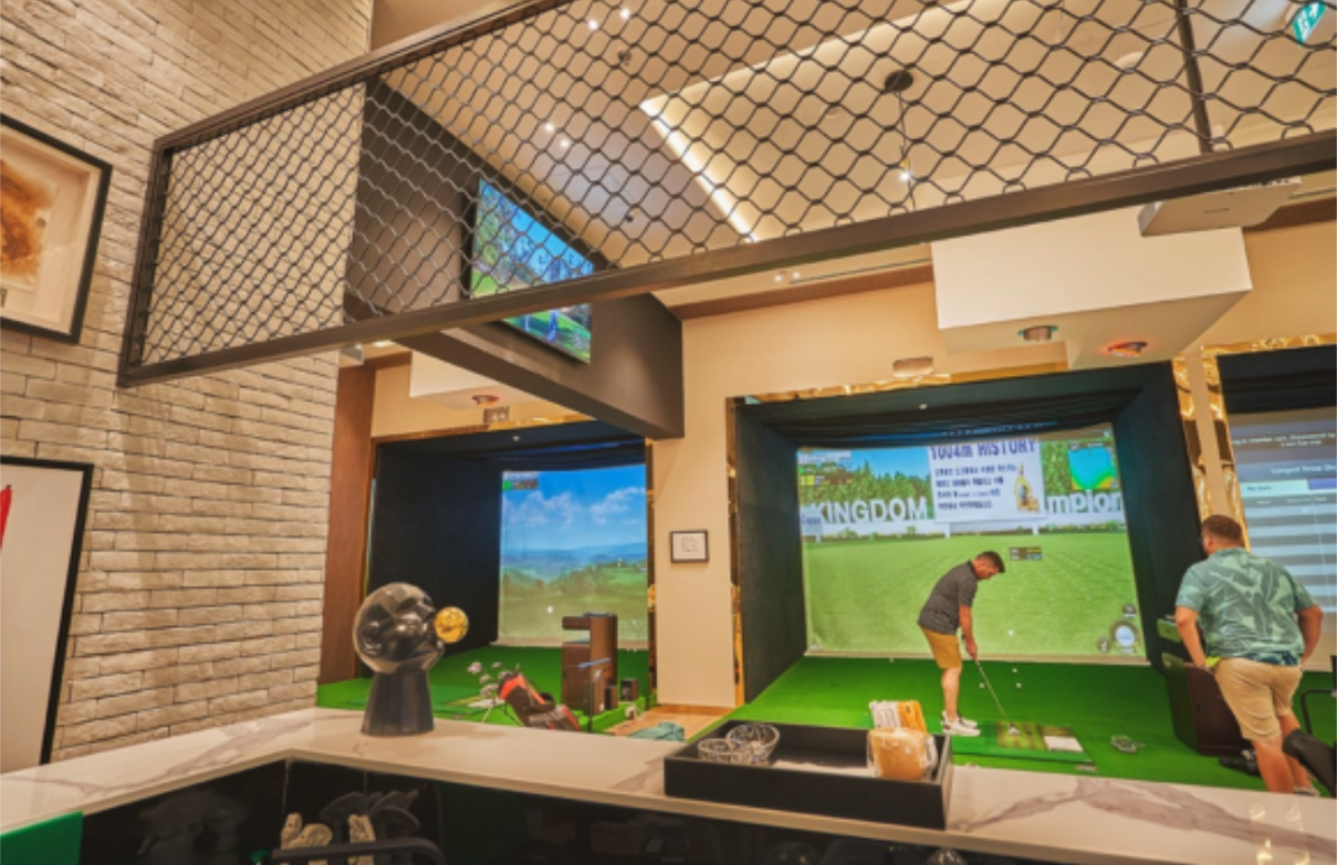 Golfers practicing with golf simulators to improve faster than the driving range through real-time swing analysis.